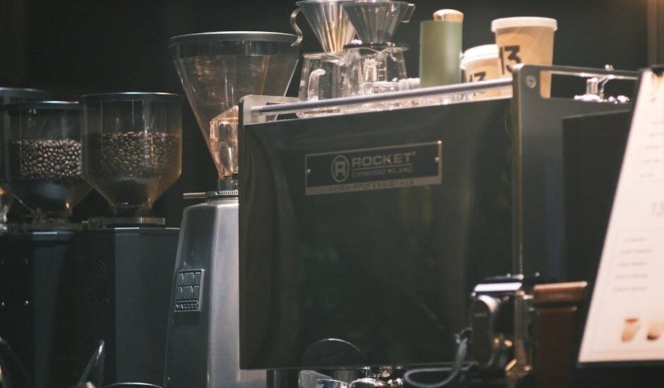 Close-up of an espresso machine in a cafe with coffee grinders and cups.
