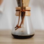 Close-up of a Chemex coffee maker with a reusable filter in use, highlighting sustainable brewing options for Chemex users.