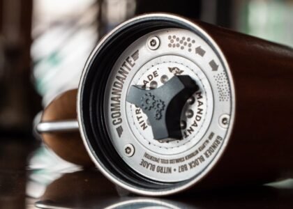 Detailed close-up image of Comandante coffee grinder emphasizing product craftsmanship.