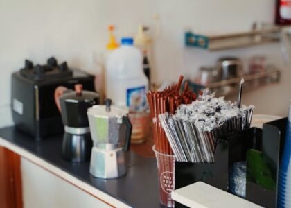 A moka pot and an electric coffee maker sit side by side on a kitchen counter, illustrating the difference between coffee maker and moka pot.