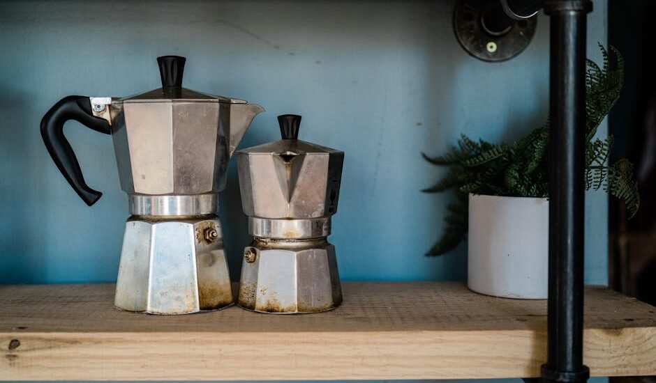 Two moka pots of different sizes on a wooden shelf, illustrating the moka pot side of the espresso machine vs moka pot comparison article