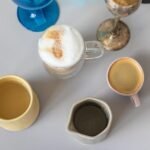 Assorted coffee drinks in different mugs and glasses, illustrating how new coffee drinks become standard menu items.