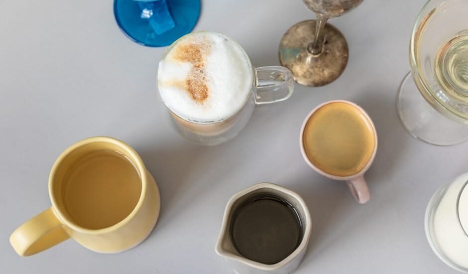 Assorted coffee drinks in different mugs and glasses, illustrating how new coffee drinks become standard menu items.