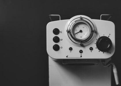 Espresso machine control panel with pressure gauge, illustrating steps for adjusting espresso machine pressure.