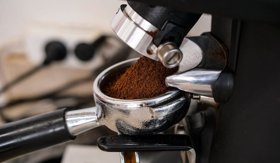 Close-up of an espresso grinder dispensing ground coffee into a portafilter, illustrating grind size adjustment for espresso preparation.