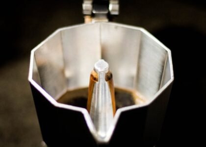 Detailed view of coffee brewing inside a classic moka pot. Perfect for caffeine lovers.