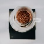 Ground coffee in an AeroPress, relevant to brewing methods discussed in the article.