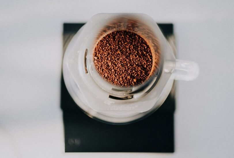 Ground coffee in an AeroPress, relevant to brewing methods discussed in the article.