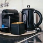 A compact espresso machine and kettle on a kitchen counter, illustrating options for small kitchens.