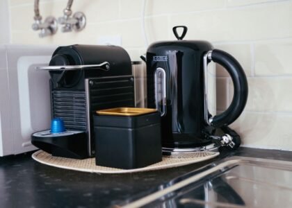 A compact espresso machine and kettle on a kitchen counter, illustrating options for small kitchens.