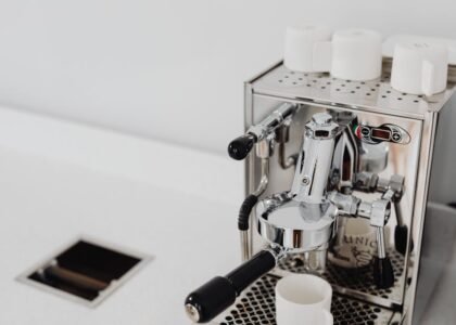 A dual boiler espresso machine with portafilter and cups, relevant to espresso brewing.