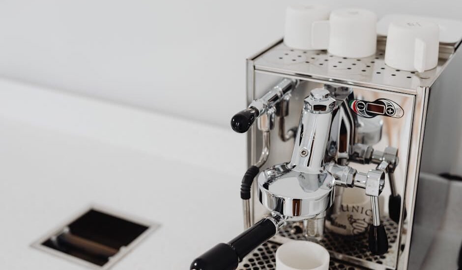 A dual boiler espresso machine with portafilter and cups, relevant to espresso brewing.