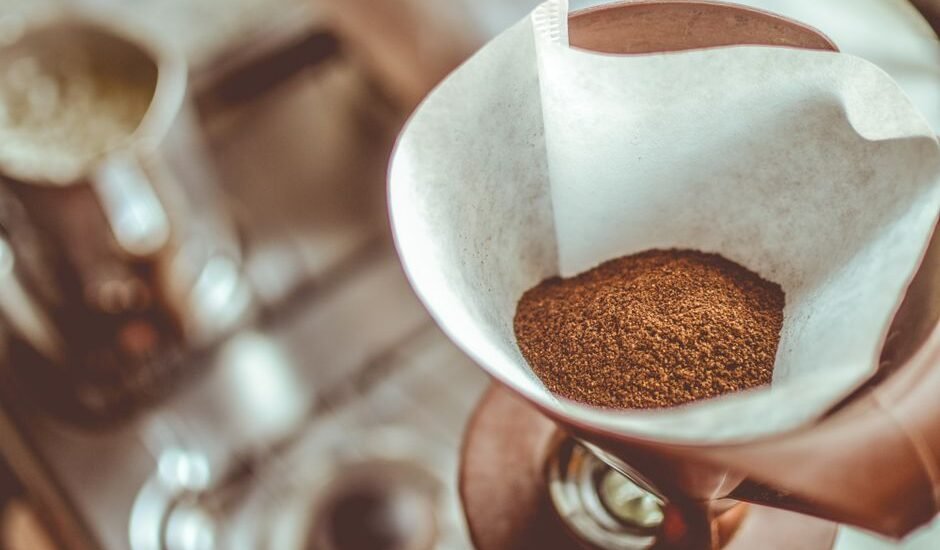 A cone coffee dripper filled with ground coffee, relevant to using basket filters.