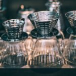 A setup showing pour-over coffee funnels and glass carafes, relevant to using a funnel for brewing.