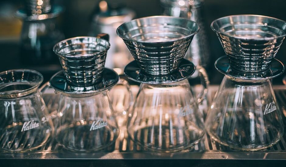 A setup showing pour-over coffee funnels and glass carafes, relevant to using a funnel for brewing.