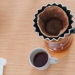 Coffee bloom process shown with a pour-over setup and brewed coffee below.