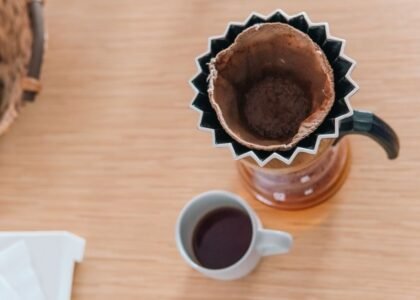 Coffee bloom process shown with a pour-over setup and brewed coffee below.