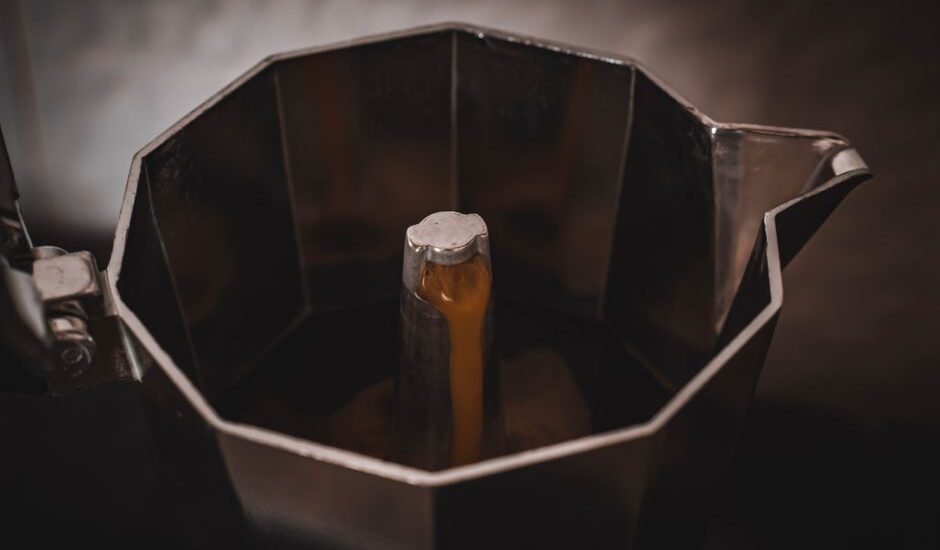 Electric moka pot brewing coffee, illustrating features for reviews.