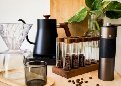 Espresso distribution tool alongside coffee beans and brewing equipment for moka pots.