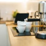 A coffee machine with stacked cups, illustrating how to prime a coffee machine.