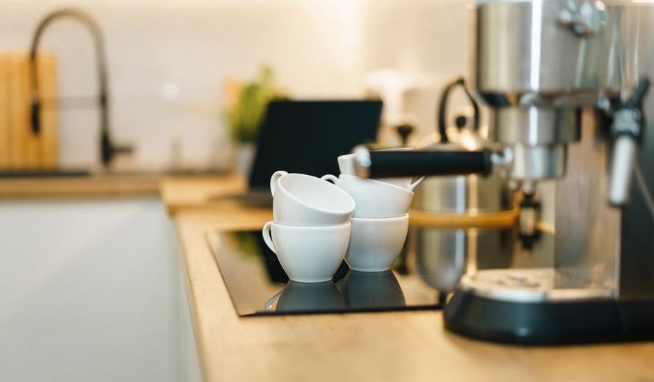 A coffee machine with stacked cups, illustrating how to prime a coffee machine.