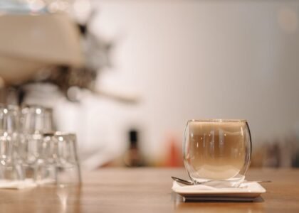 A clear double wall cup filled with coffee, illustrating the difference in cup design.