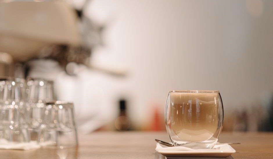 A clear double wall cup filled with coffee, illustrating the difference in cup design.
