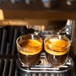 Two espresso shots in clear glasses, illustrating channeling in espresso extraction.
