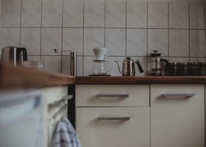 A coffee brewing setup featuring a pour-over dripper, kettle, and French press, relevant to cleaning tablets for grinders.