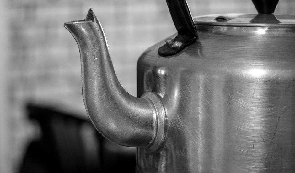 A kettle spout with visible limescale buildup, relevant to removing limescale.
